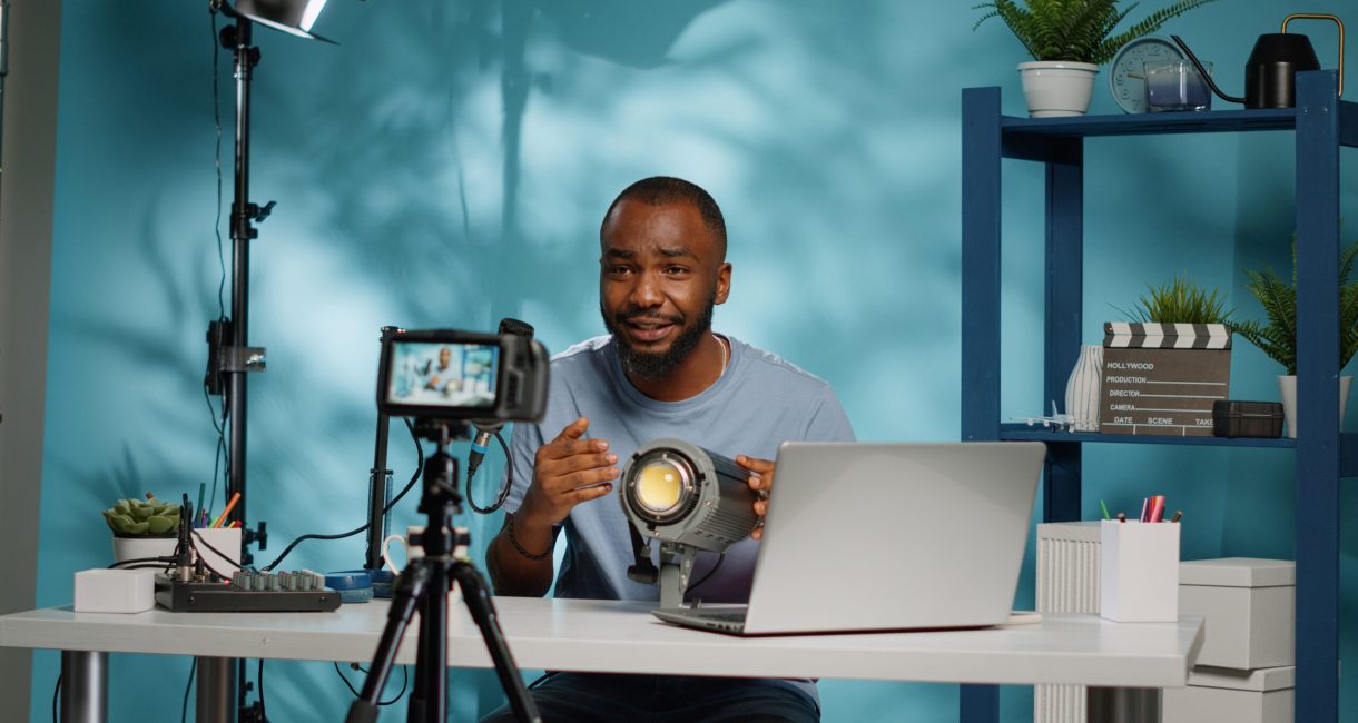 African american blogger reviewing studio light on camera for vlog channel. Black influencer doing recommendation and review product used for videography equipment on video podcast.